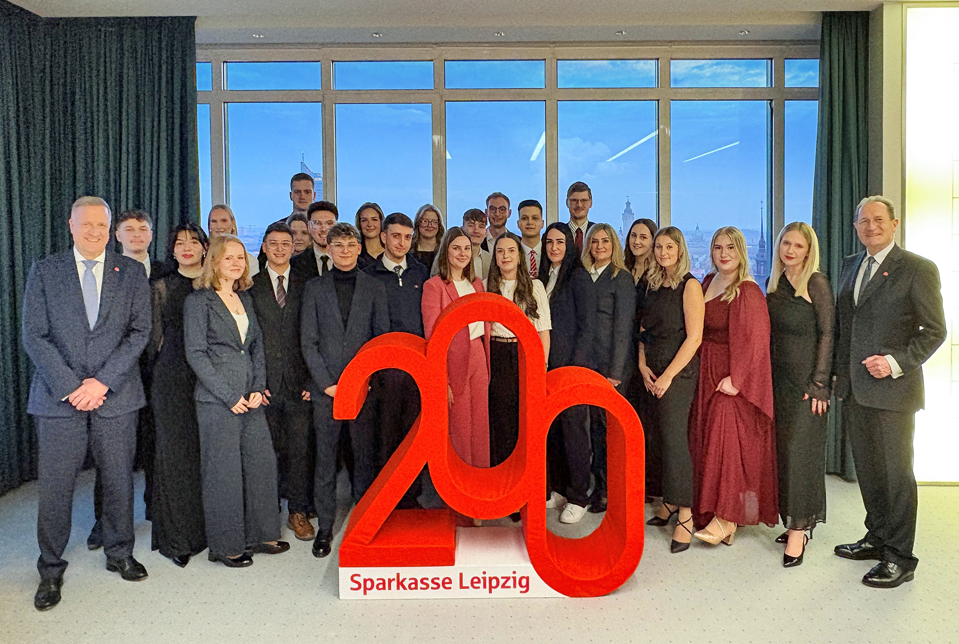 Trainees of Sparkasse Leipzig celebrate the completion of their training at the 200-year anniversary lettering